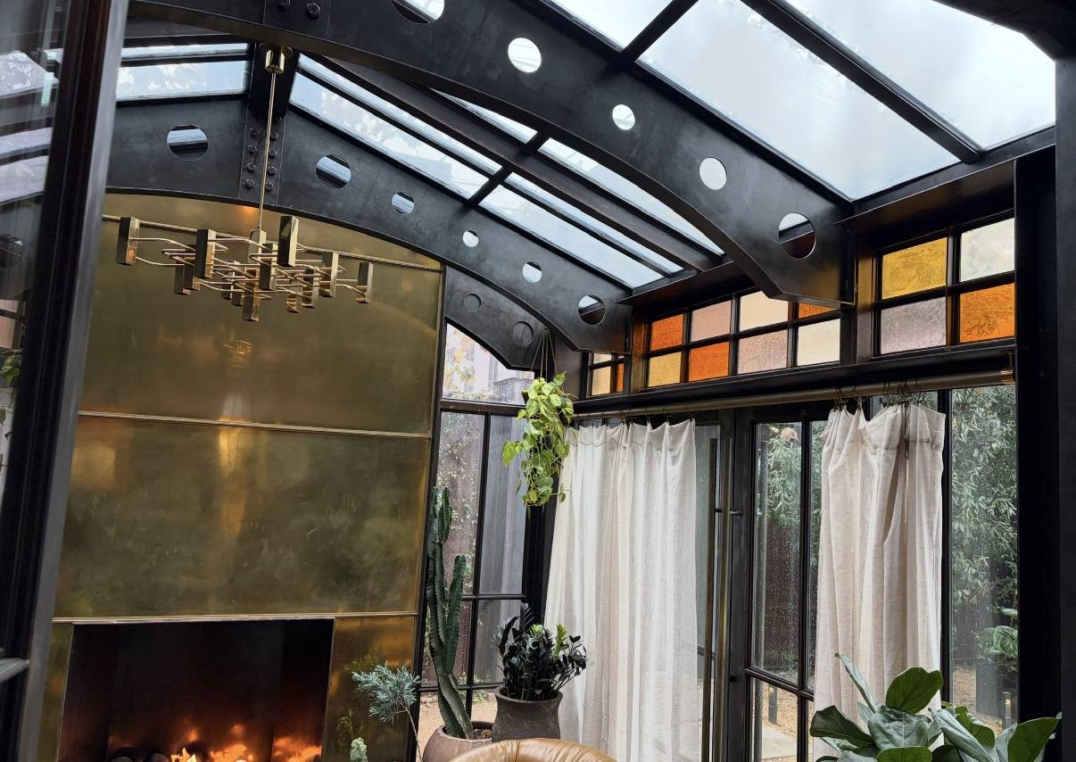 Glass roofed steel room with amber and textured stained glass clerestory windows